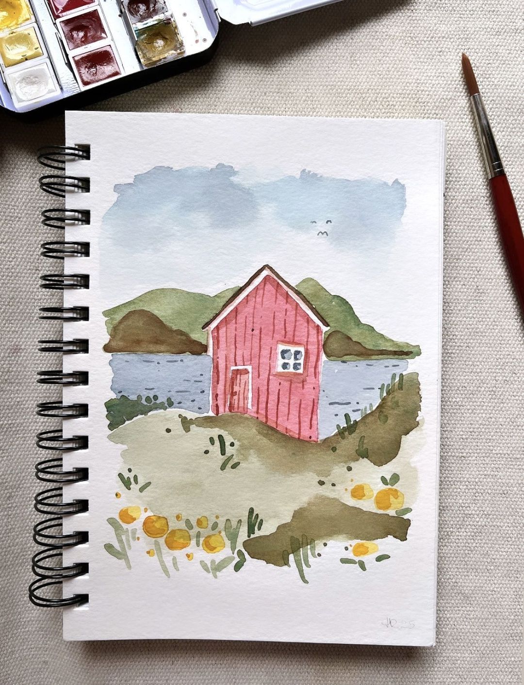Skizzenbuch mit Aquarell Haus See Blumen Berge