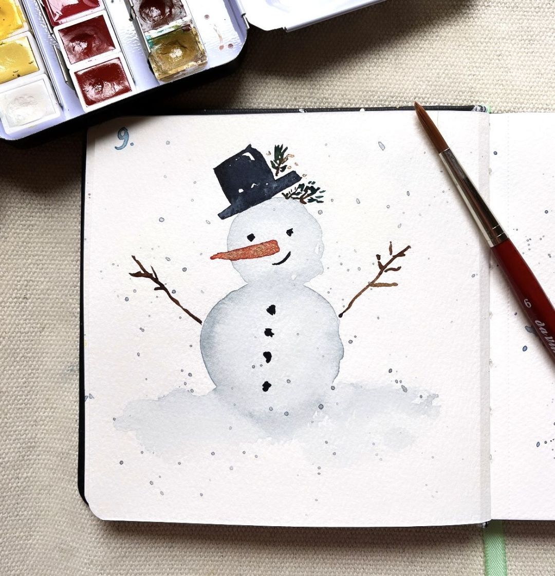 Aquarell Skizzenbuch mit Schneemann Karottennase Zylinderhut